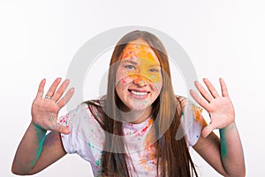 Colorful, fun and people concept - young woman showing her hands in colors on the festival of holi