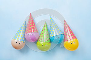 Colorful funny balloons on blue table top view. Festive or party background. Flat lay. Birthday greeting card.