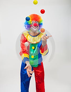 Colorful funny clown juggling balls