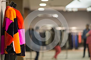 Colorful fur coat in the leather and fur shop