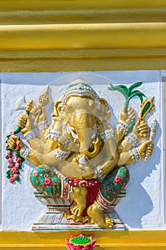 Colorful Ganesha Hindu god avatar images in stucco low relief white wall at the public Wat Samarn temple, Chachoengsao, Thailand.