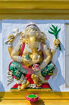 Colorful Ganesha Hindu god avatar images in stucco low relief white wall at the public Wat Samarn temple, Chachoengsao, Thailand.