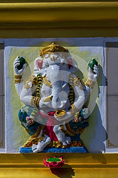 Colorful Ganesha Hindu god avatar images in stucco low relief white wall at the public Wat Samarn temple, Chachoengsao, Thailand.