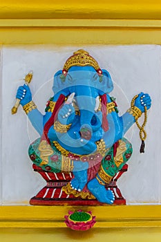 Colorful Ganesha Hindu god avatar images in stucco low relief white wall at the public Wat Samarn temple, Chachoengsao, Thailand.