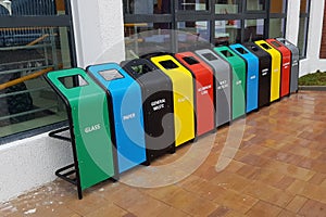 Colorful garbage bins for recycling, garbage separation. Containers for glass, paper, general waste, plastic, aluminum cans.