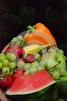 Colorful garden produce in wooden bowl