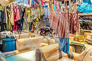 Colorful garments on clotheslines in bright sunlight photo