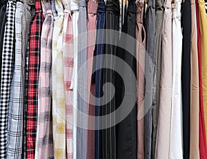 Colorful garments hang on a rack