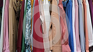 Colorful garments hang on a rack