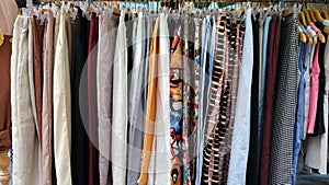 Colorful garments hang on a rack