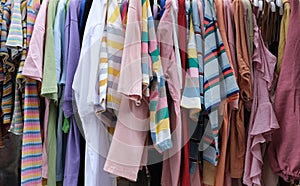 Colorful garments hang on a rack