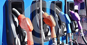 Colorful gas pump nozzle at service station and and gasoline distributor