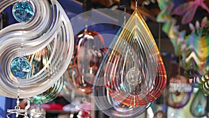 Colorful geometric metallic wind spinner, garden hypnotic surreal decoration, California USA. 3D kinetic rotating iridescent