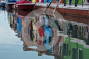 Colorful geometry photo of a houses reflected in water, Burano island