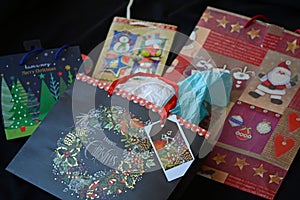 Colorful gift bags on display with a floral backdrop.