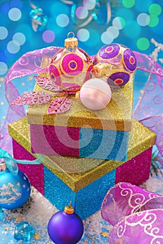 Colorful gift boxes with christmas baubles