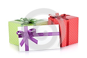 Colorful gift boxes and letter with ribbon and bow