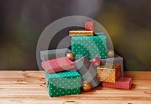 Colorful gifts and christmas balls on dark background