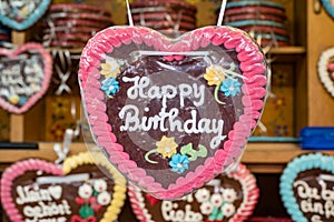 Colorful gingerbread sweetheart bearing the inscription Happy birthday