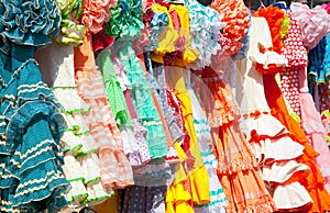 Colorful gipsy dresses in rack hanged in Spain