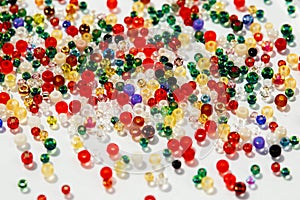 Colorful glass beads on white background, close up photo.
