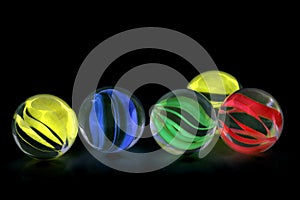 Colorful glass marbles on black background