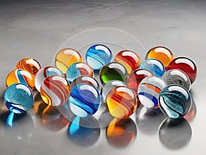 Colorful glass marbles on gray background.