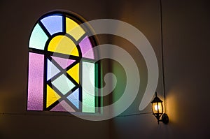 Colorful glass window with lamp light