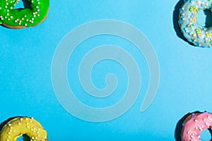 Colorful glazed donuts on a bright background