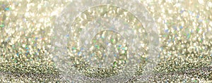 Colorful glitter banner with lights, bokeh. Shiny festive greeting card. New year and Christmas concept. Sparkling textured