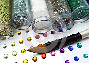 Colorful glitter and rhinestone crafts with brush