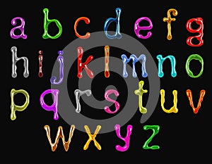 Colorful glossy small latin letters drawn with paint isolated on a black background