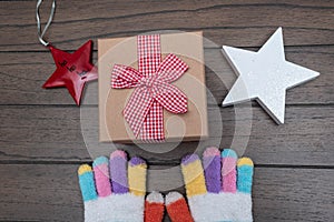 Colorful gloves and christmas present with red ribbon