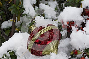 Colorful glowing christmas ball on the snow