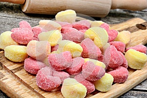 Colorful gnocchi hearts on a old table