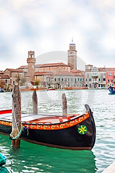 Colorful gondola boat at the water, venetian houses and canal view