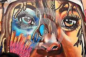 Colorful graffiti art and street murals. Beautiful woman`s eyes.