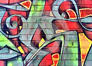 Colorful graffiti detail on a brick wall