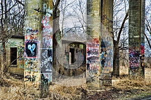 Colorful graffiti painted on columns of old concrete coal chute.