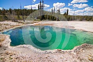 Colorful green Abyss Pool hot spring in West Thumb Geyser Basin in Yellowstone National Park