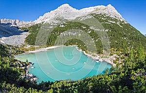 Colorful green water of lake Sorapis in italian dolomite landscape