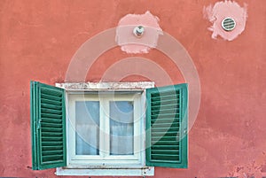 Colorful green window and orange old building facade in beautiful village Lerici, Liguria Italy