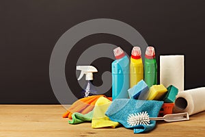 Colorful group of cleaning supplies on dark background