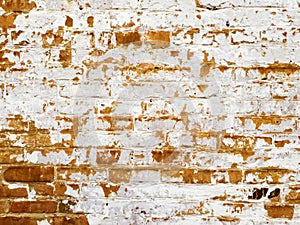 Colorful grunge texture of an old red brick wall with damage and peeling white paint