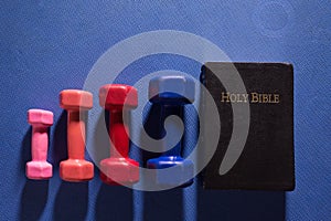 Colorful Gym Weights and Holy Bible