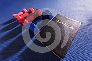 Colorful Gym Weights and Holy Bible