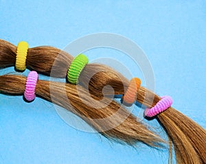 Colorful hair ties on a blue background.