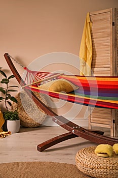 Colorful hammock with pillow in room interior
