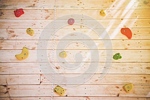 Colorful hand and footholds on a climbing wall