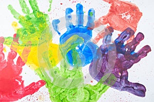 Colorful hand paint from kids hands on white paper
